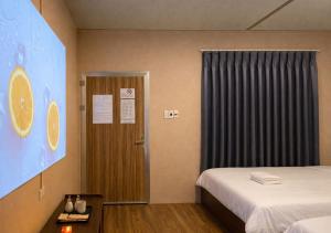 a hotel room with two beds and a door at Mai Ve Home in Lương Xâm
