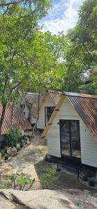 a group of houses with trees in the background at La Lune's Koh Tao in Ko Tao +6 photos