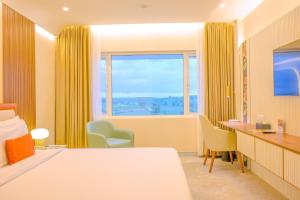 a hotel room with a bed and a window at Terrea by Wonderla in Kumbalgod +51 photos