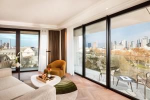 a living room with a view of a city at Kennedy 89 Hotel Frankfurt, part of Hyatt in Frankfurt