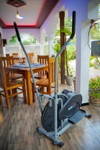 an exercise bike in a room with a table at Guru Guest House in Trincomalee