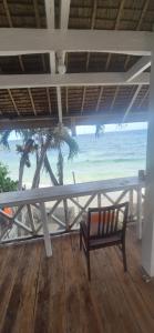 a bench sitting on a porch with a view of the beach at Bohol Panglao Paradise Villa in Panglao Island +4 photos