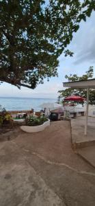 a view of the ocean from a patio with an umbrella at Bohol Panglao Paradise Villa in Panglao Island