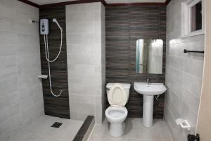 a bathroom with a toilet and a sink at La Elliana Hotel & Restaurant, Inc. in Laoag