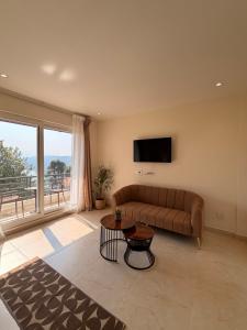 a living room with a couch and a flat screen tv at Barylia in Mawlyngkhung