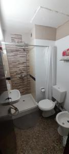 a bathroom with a toilet and a sink and a shower at Departamento PyA in San Miguel de Tucumán +46 photos
