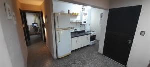 a kitchen with a white refrigerator and a stove at Departamento PyA in San Miguel de Tucumán