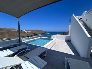 a view of the ocean from a villa with a swimming pool at The Eagle Merchia Mykonos in Merchia Beach