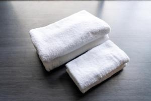 two white towels sitting on top of a table at Umi no SOBA 伊豆 - BBQ & Sauna in Ito +107 photos