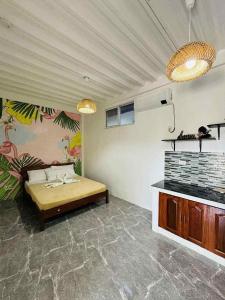 a room with a bed and a wall with a mural at Samaravilla in Tagbilaran City