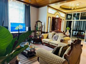 a living room with a couch and a tv at Samaravilla in Tagbilaran City
