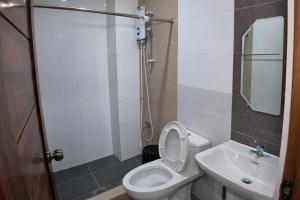 a bathroom with a toilet and a sink at La Elliana Hotel & Restaurant, Inc. in Laoag +6 photos