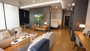 a living room with a couch and a bed at Kwangsu Hotel Haeundae in Busan