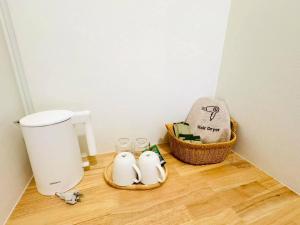 a corner of a bathroom with a toilet and two birds on the floor at Rabbit Villa Bangsaray in Bang Sare