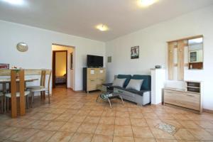 a living room with a couch and a table at APARTMANI DELAS in Pješčana Uvala