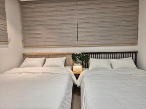 two beds sitting next to each other in a bedroom at Cozystay-Beomeo in Hyomoktong-Ilgu