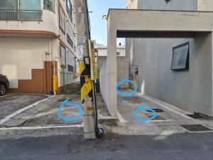 a parking meter with blue handles on a city street at Cozystay-Beomeo in Hyomoktong-Ilgu