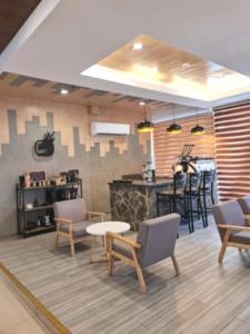a room with chairs and a table and a counter at Star Hotel Davao in Davao City