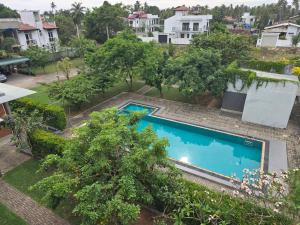 an overhead view of a swimming pool in a yard with houses at Amadel Negombo in Negombo