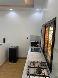 a kitchen with a stove and a counter top at Modern studio close to the TER train station in Dakar +5 photos