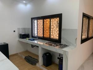 a room with a table with a window on it at Modern studio close to the TER train station in Dakar