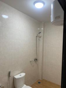 a bathroom with a toilet and a shower at Modern studio close to the TER train station in Dakar