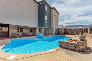 a swimming pool in the backyard of a house at Comfort Inn & Suites McComb in McComb