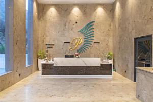 a lobby with a reception desk and a sign on the wall at Echor Palm Bliss Resort & Spa, Kasol in Kasol