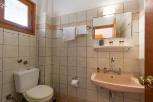 a bathroom with a toilet and a sink at Sailor's Apartments Kavos in Kavos +25 photos