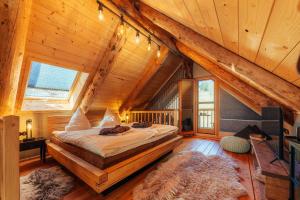 a bedroom with a bed in a room with wooden ceilings at Blockhaus PanHütte in Braunlage