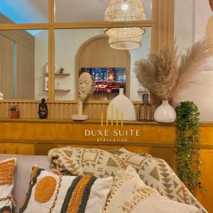 a living room with a duke mattress sign and a mirror at Cozy Vibes near MOA & NAIA AIRPORT with NETFLIX,MINIVIDEOKE,BOARDGAMES-DUXE3 in Manila