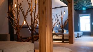a living room with a couch and a mirror at Hotel Leinsweiler Hof in Leinsweiler +71 photos