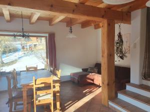 a dining room with a wooden table and chairs at Biohof Prannleithen - Knusperhaus in Yspertal