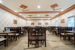 a dining room with wooden tables and chairs at Desert Story Night Camp in Jaisalmer