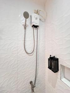 a shower with a blow dryer in a bathroom at Puyo Suites Homestay in General Luna +110 photos