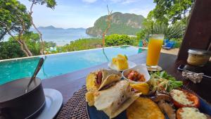 a plate of food on a table with a drink at The Cocoon - Glamping at Karuna El Nido in El Nido