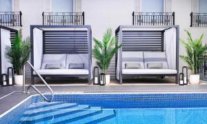 two chairs sitting next to a swimming pool at The Brock Niagara Falls Fallsview, Tapestry by Hilton in Niagara Falls