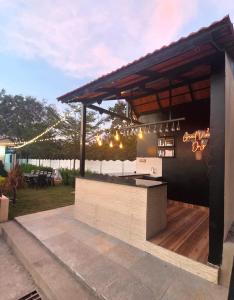 an outdoor kitchen with a bar in a backyard at Aacasa Living Resorts in Shamshabad