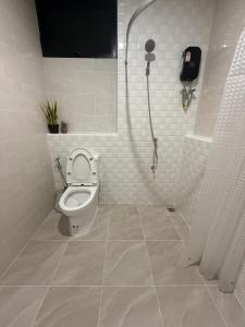 a bathroom with a toilet and a shower at Cha V Place Buriram - ชาวีเพลส บุรีรัมย์ in Ban Yang +24 photos