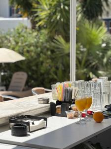 a table with glasses and drinks on it at Athina Studios in Vathí