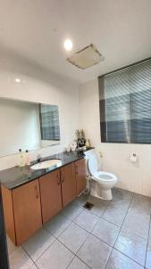 a bathroom with a toilet and a sink at 6A SANTUBONG SUITES by MF in Kuching +24 photos