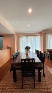a dining room with a table and chairs in a room at 6A SANTUBONG SUITES by MF in Kuching