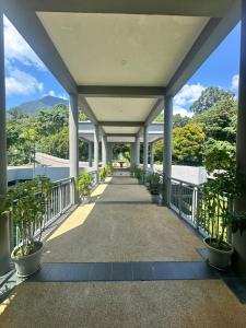 a walkway in a building with potted plants at 6A SANTUBONG SUITES by MF in Kuching
