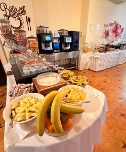 a buffet with bananas and other fruit on a table at Hotel Principe in Sanremo
