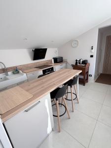 a kitchen with a wooden counter top and a sink at Les hauts de Vaison in Vaison-la-Romaine +22 photos