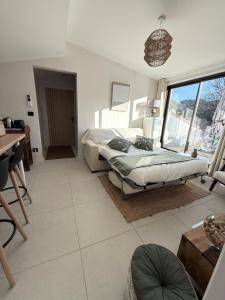 a bedroom with a bed and a table and a window at Les hauts de Vaison in Vaison-la-Romaine