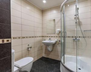 a bathroom with a toilet sink and a shower at Семеен Хотел Опера in Burgas +49 photos
