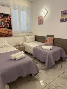 a living room with two beds and a couch at Casa Vacanze Villa Mimosa- per le vacanze vicino a Tropea in Briatico +68 photos