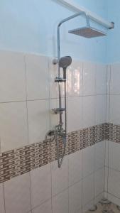 a shower in a bathroom with a shower head at Zai Homes Watamu in Watamu +33 photos