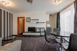 a living room with a couch and a table at Семеен Хотел Опера in Burgas